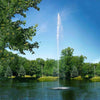 Image of Scott 1-1/2HP Pond Fountain Jet Stream Pattern by Scott Aerator Operating in a Pond with Trees at the Back 13524