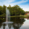 Image of Scott 1/2HP Pond Fountain Gusher Pattern by Scott Aerator Operating in a Pond with Trees at the Back 13513
