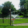 Image of Kasco 1HP Aerating Fountain 4400VFX with V-Shape Pattern Operating in a Pond Surrounded by Plants 115V/230V