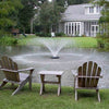 Image of Kasco 1/2HP Aerating Fountain 2400VFX  Operating in a Pond in Front of a House Surrounded by Trees