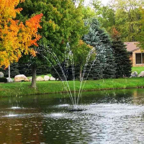 Scott 1/2HP Pond Fountain Chesapeake Pattern by Scott Aerator Operating in a Pond with Trees at the Back 13530