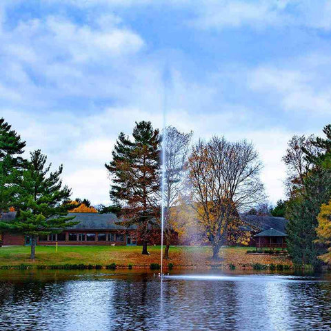 Scott 1/2HP Pond Fountain Jet Stream Pattern by Scott Aerator Operating in a Pond with Trees at the Back 13522