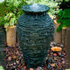 Image of Aquascape Small Stacked Slate Urn Kit Operating in a Garden 58064