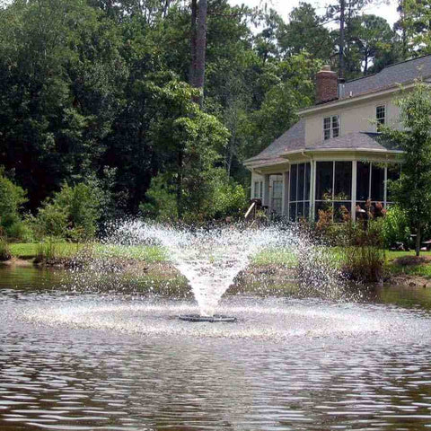 Kasco 1/2HP Aerating Fountain 2400VFX  Operating in a Pond in Front of a House Surrounded by Trees