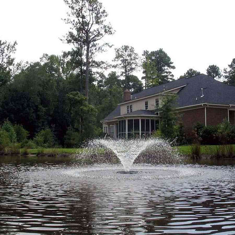Kasco 1/2HP Aerating Fountain 2400VFX  Operating in a Pond in Front of a House Surrounded by Trees