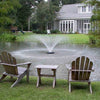 Image of Kasco 1/2HP Aerating Fountain 2400VFX  Operating in a Pond in Front of a House Surrounded by Trees