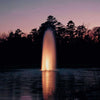 Image of Kasco 5HP Decorative Fountain 5.1JF 5.3JF 230V with Spruce Pattern Operating in a Pond with Trees at the Back at Night with Orange Lights