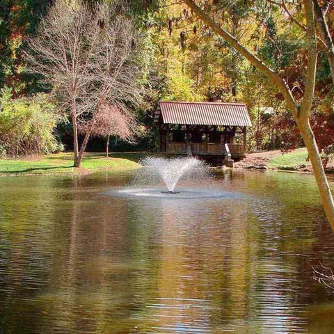 Scott 1/2HP Display Aerator Operating in a Pond with Trees and a Cottage at the Back DA-20 14020