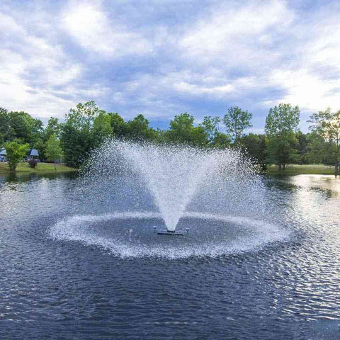 Scott 1.5HP North Star Fountain Displat Aerator Operating in a Pond with Trees at the Back 14026